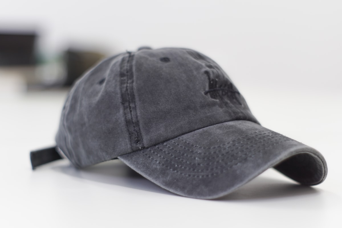 Person wearing a custom embroidered trucker cap