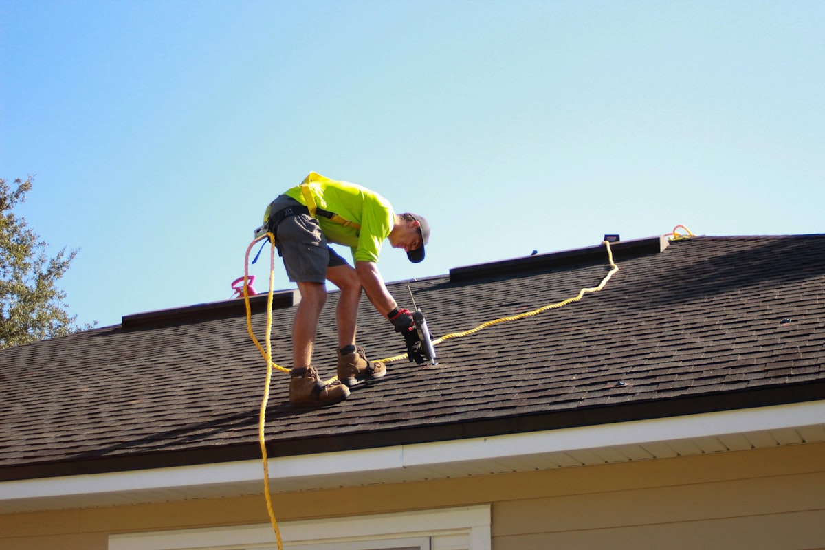 Roofer on a residential job wearing branded company hat