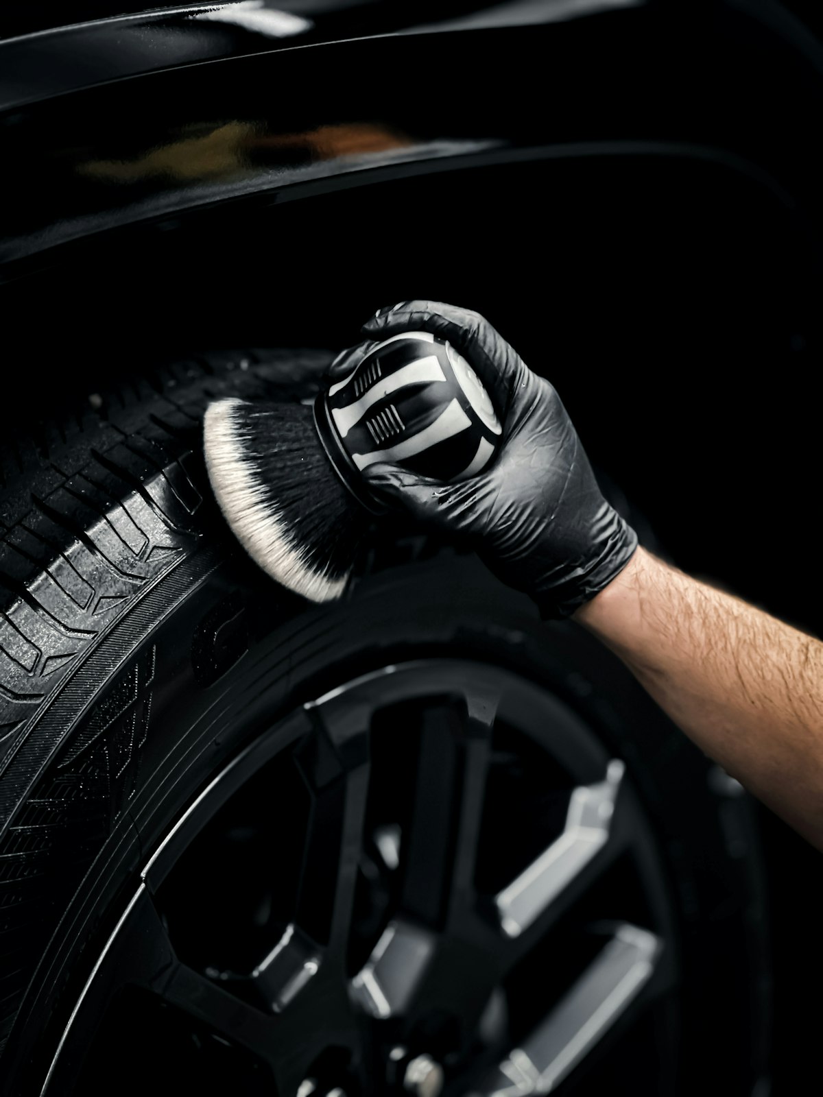 Auto detailer working on a car exterior