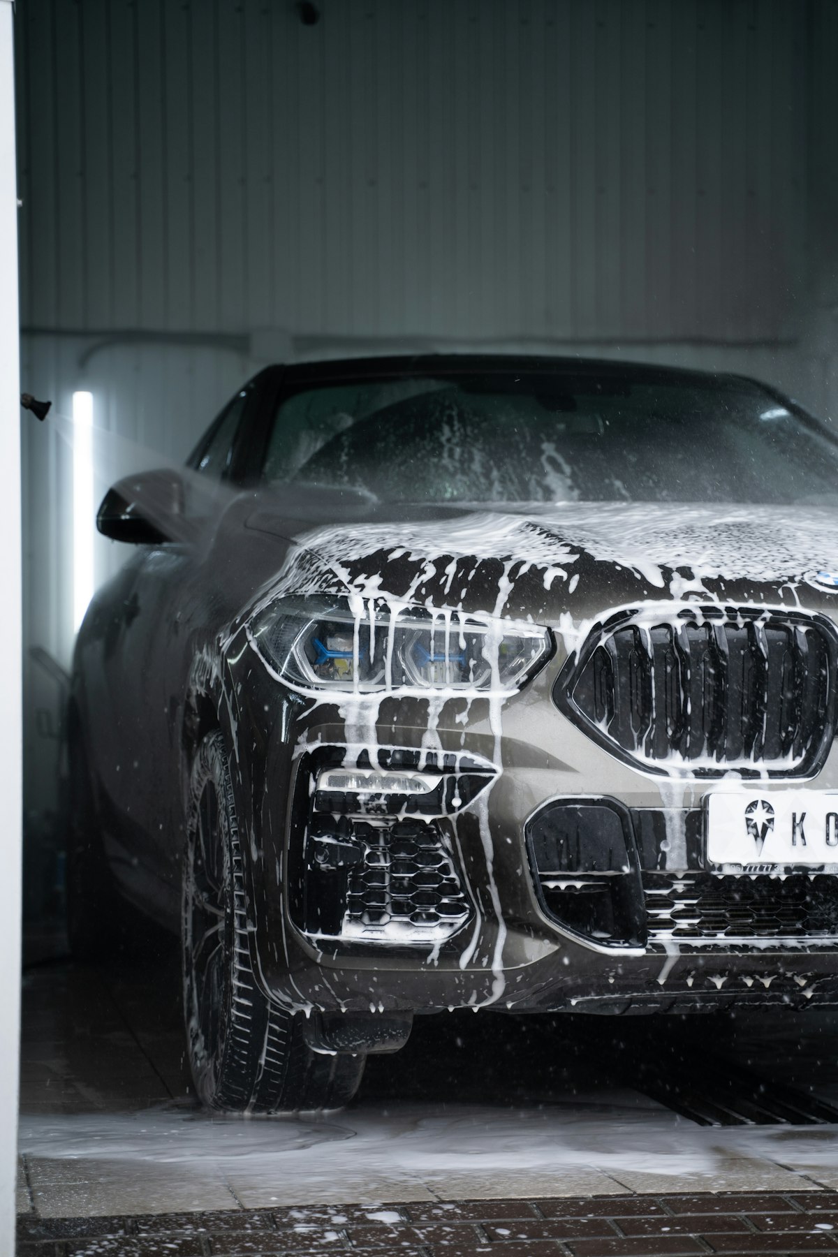 Car wash exterior with professional staff in branded hats