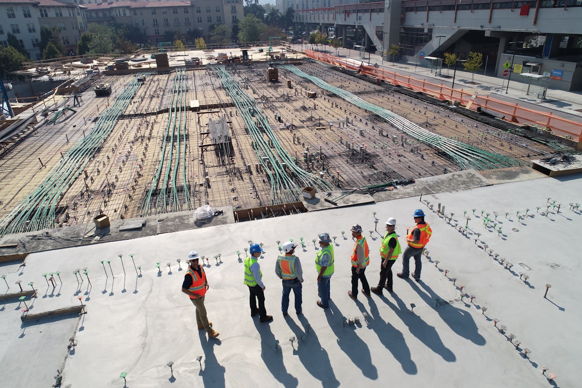General contractor crew wearing branded hats on a job site