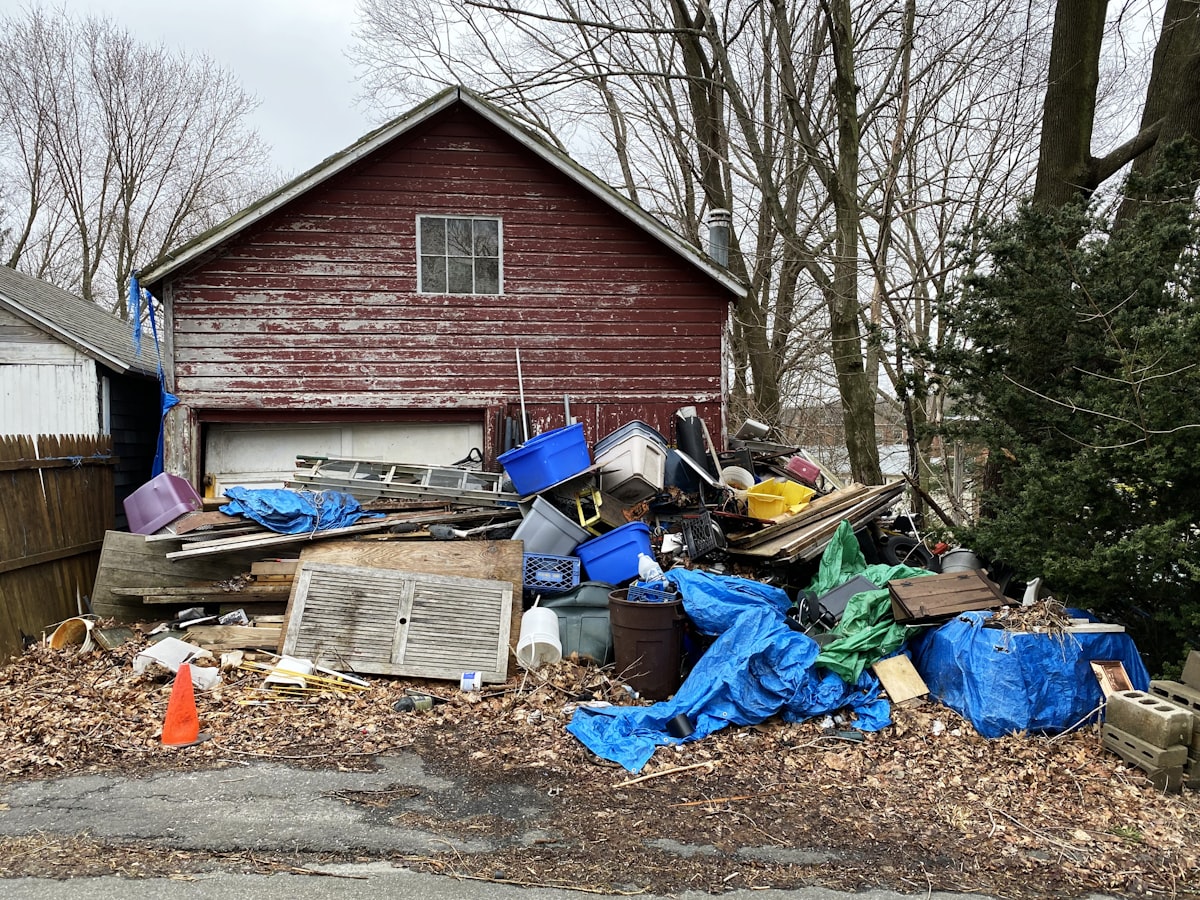Roll-off dumpster staged in a residential driveway for a junk removal job