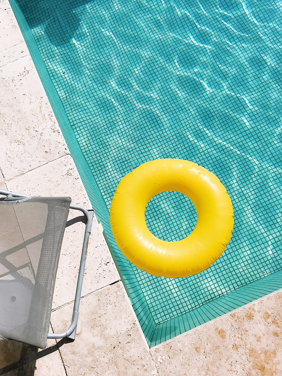 Pool service technician wearing a branded custom hat while working